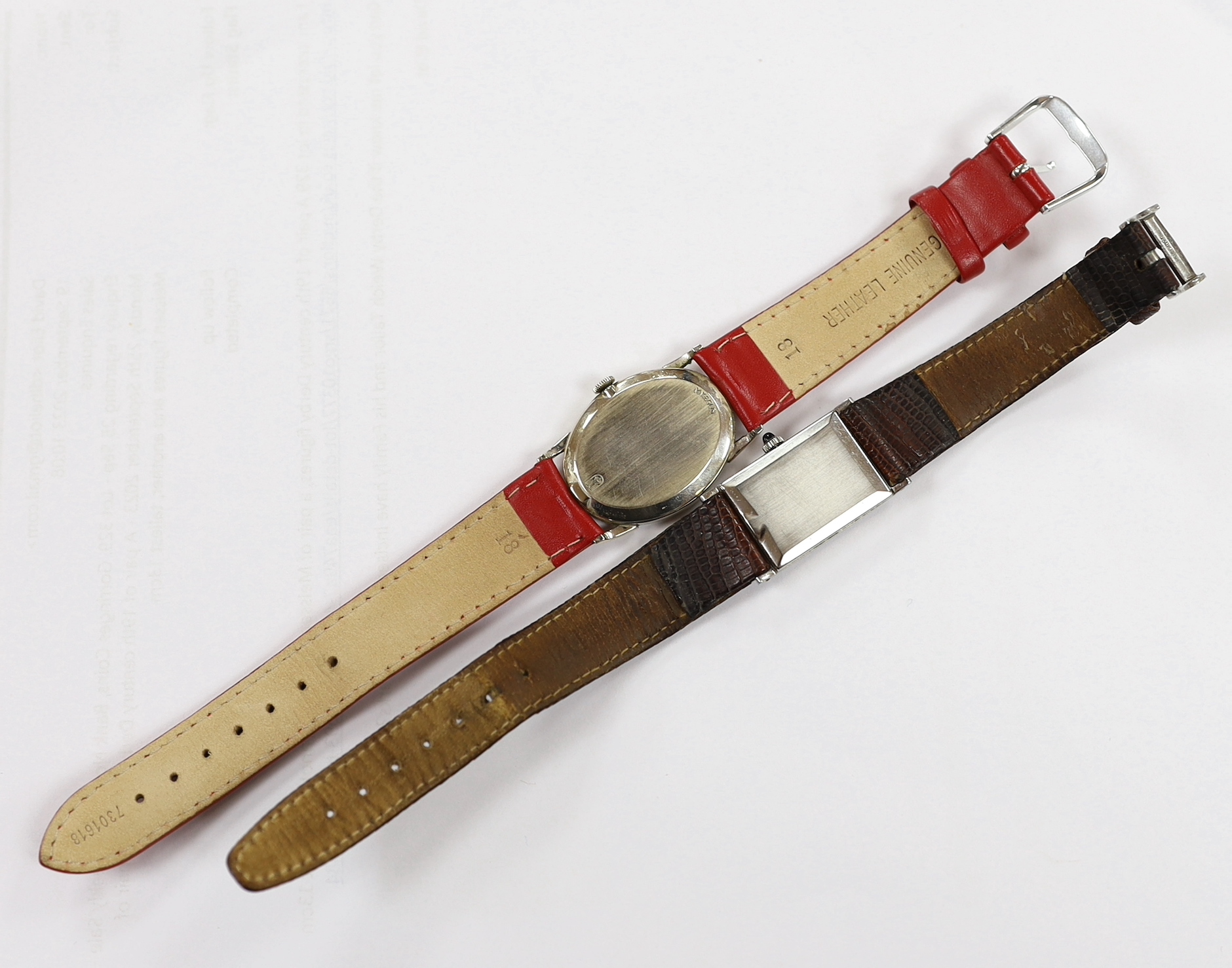A 14k white metal Jules Jurgensen oval manual wind dress wrist watch, on an associated red leather strap, together with a lady's steel Juvenia manual wind wrist watch.